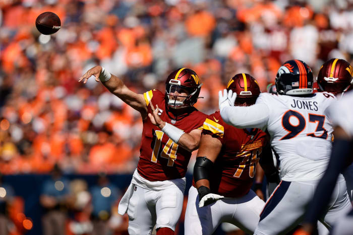 Sep 17, 2023; Denver, Colorado, USA; Washington Commanders quarterback Sam Howell (14) attempts a pass as offensive tackle Sam Cosmi (76) defends against Denver Broncos defensive tackle D.J. Jones (93) in the first quarter at Empower Field at Mile High. Mandatory Credit: Isaiah J. Downing-USA TODAY Sports